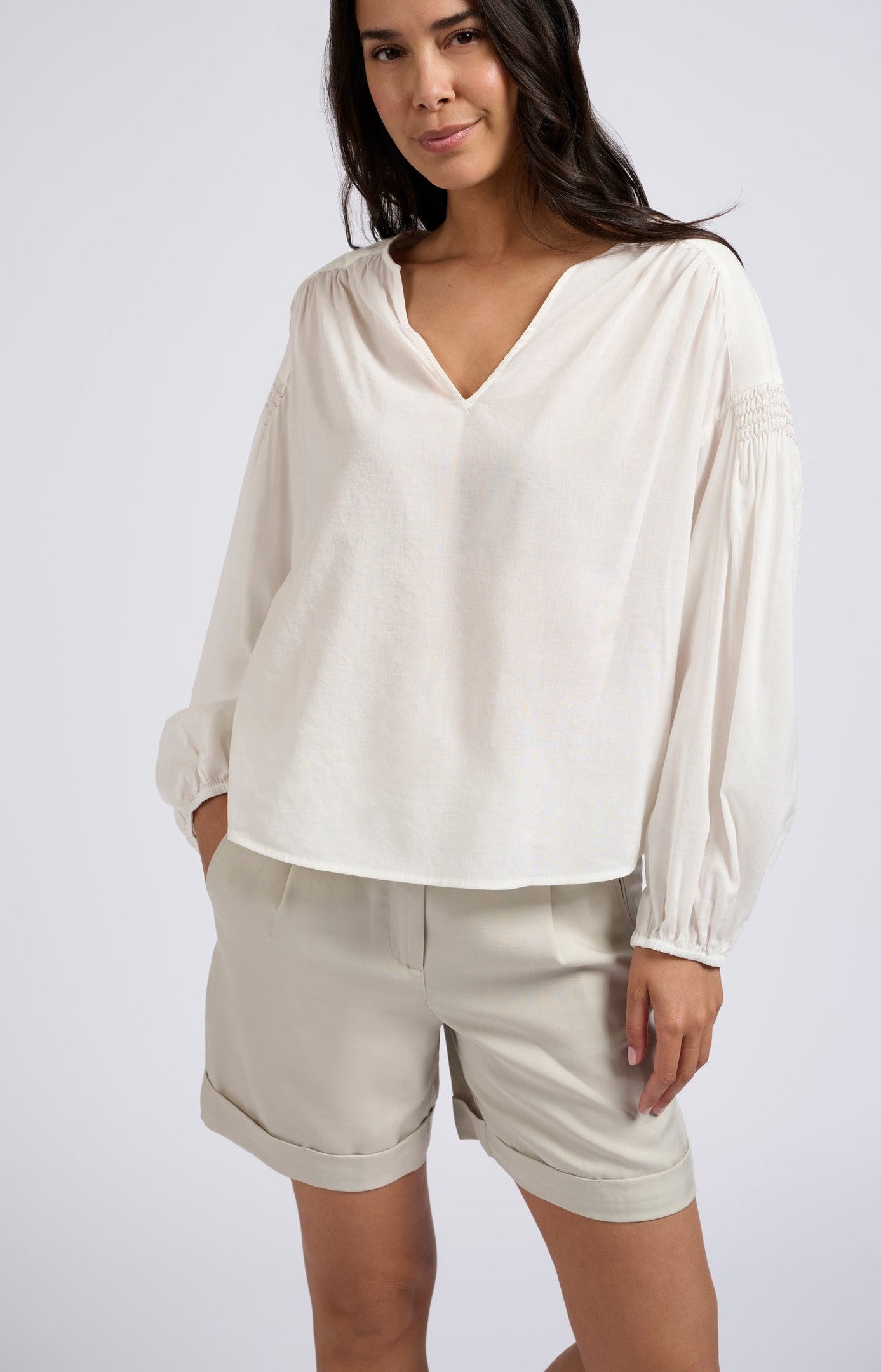 Woven top with V-neck, long sleeves and shoulder details